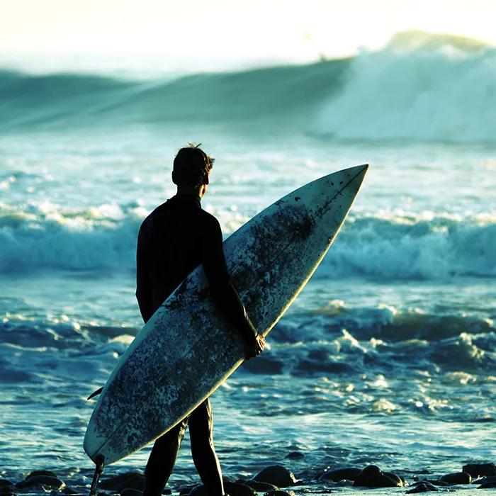Surfer along the shore