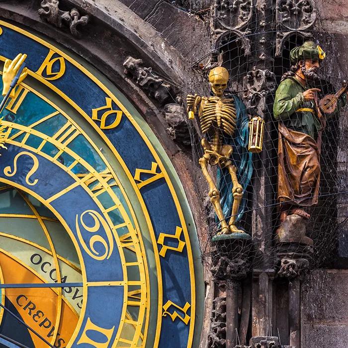 Death stands on the right side of the clock