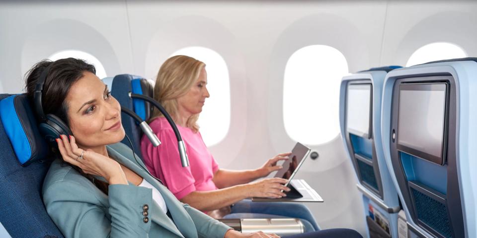 Woman with head phone in Premium Comfort class