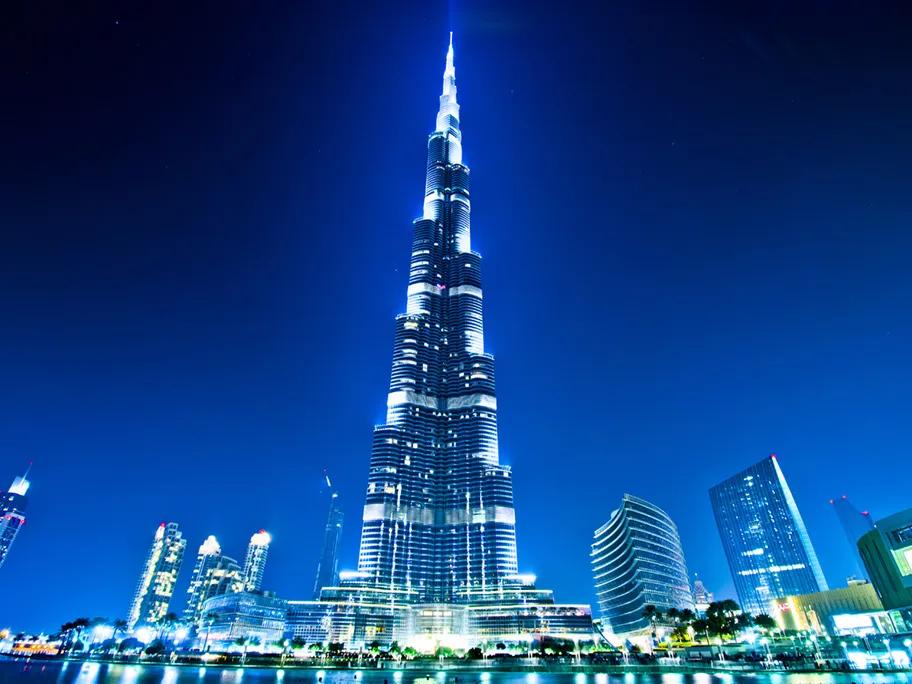A blue glow frames the Burj Khalifa