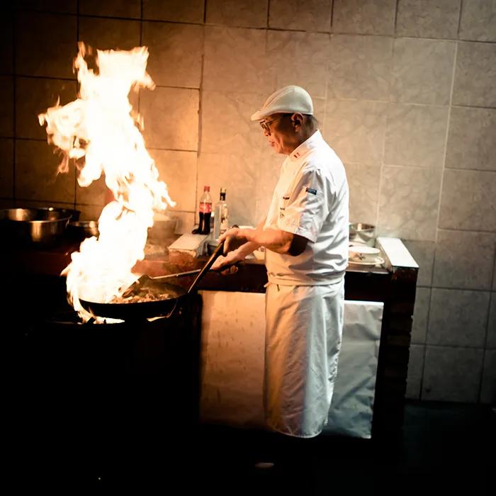 A chef preparing food at Chez Wong
