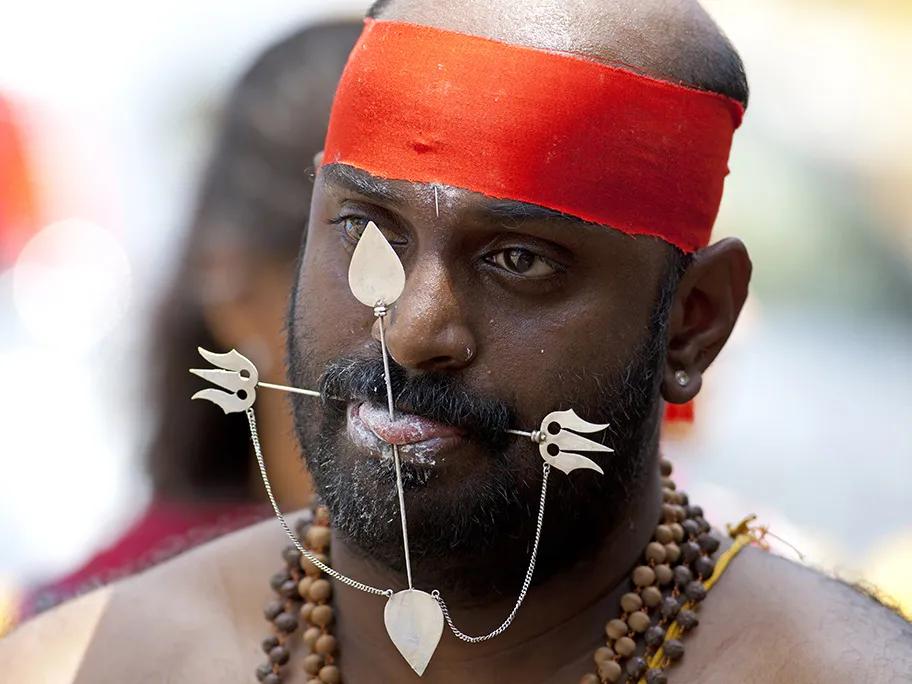 A kavadi pierces the tongue and cheeks