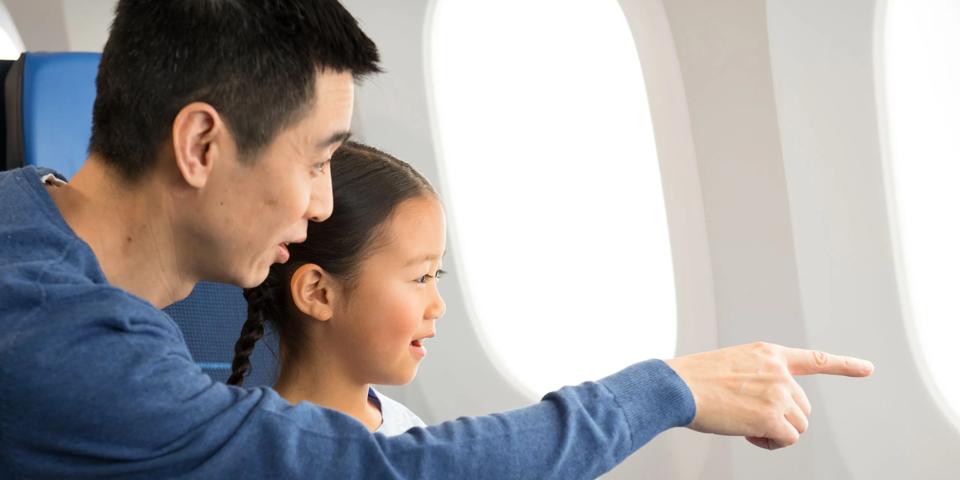 Father with daughter in Economy Class
